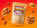Pelican Peaks Butter Pecan Pancake Mix pouch with pancakes, syrup, and pecans